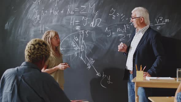 Female College Student Reciting a Lesson to Professor and Groupmates alt