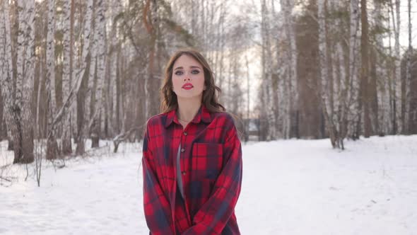 Charming Female with Long Hair Walking in Snowy Forest