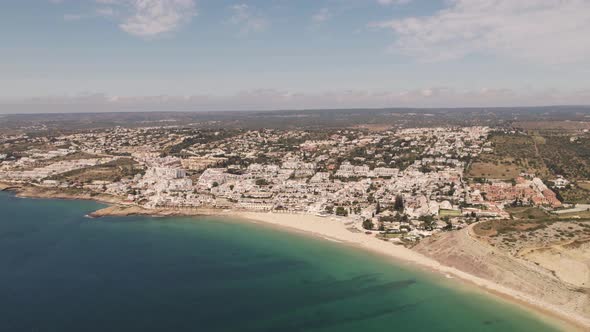 Sprawling beach town of Praia da Luz by the Atlantic Ocean and beach. Panoramic aerial view alt