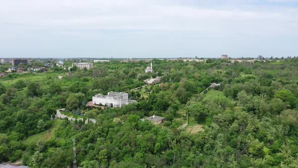 Panoramic view of the city. City buildings among the trees.