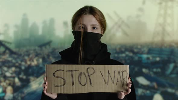 Woman Wearing Face Mask with STOP WAR on Cardboard Destruction on Background alt
