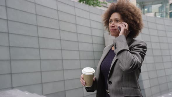 Businesswoman using smart phone and on the move