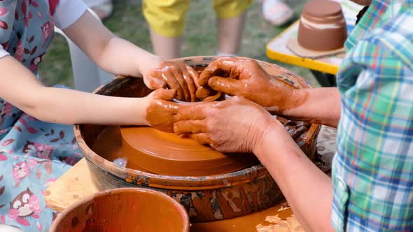 Woman and Girl Making Ceramic Pot in Pottery Workshop alt