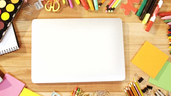 Close-up of laptop with various stationery alt