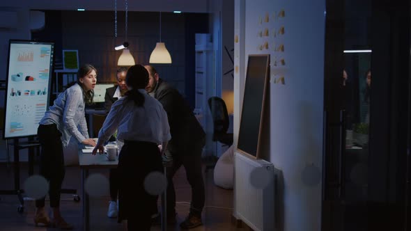 Multi Ethnic Businesspeople Teamwork Standing at Conference Table Analyzing Management Graphs alt