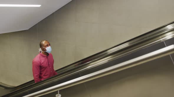 African american man on the go wearing coronavirus covid19 mask alt