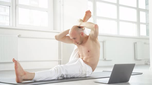 Shirtless Yogi Man Showing Yoga Exercises at Laptop Camera