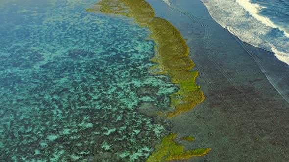 High Aerial Drone Flight Over Coral Reef Melasti Beach Bali Indonesia alt