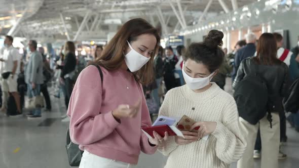 Two Women in Medical Mask Portrait Laughing and Talking in Airport Terminal Preventing Themselves alt