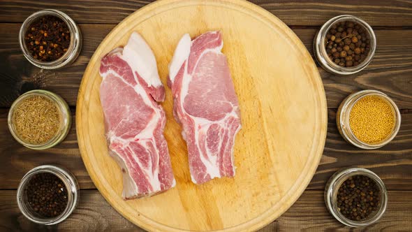 The cook lays out the meat on the board. A man prepares beautiful pieces of meat with ribs