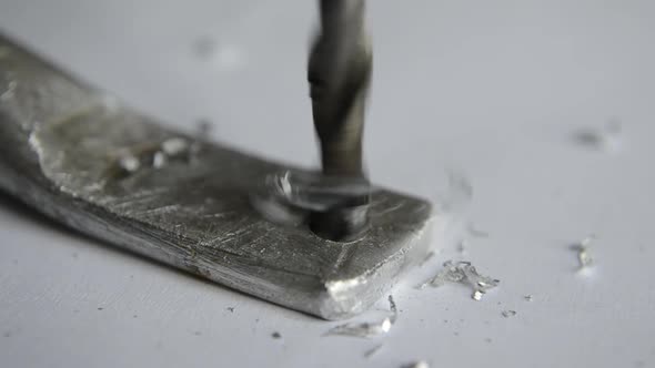 drilling of duralumin metal with a hand drill at home. alt