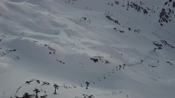 Snowy Mountain Skilifts and Furniculars and Skislopes in Austrian Alps Drone Flyover the Mountains