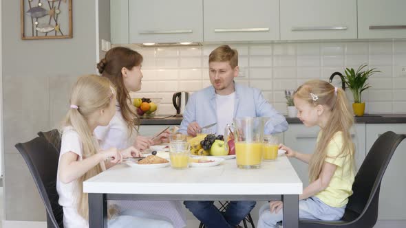Happy Family Talking During Breakfast