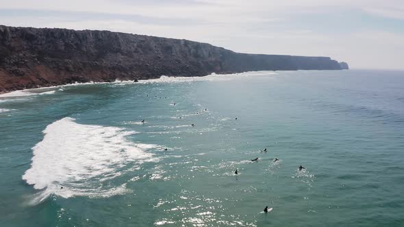 Aerial footage of surfers on the west coast of Portugal.