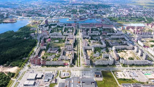 Drone suburban panorama. River, park and residential buildings under cloudy sky alt