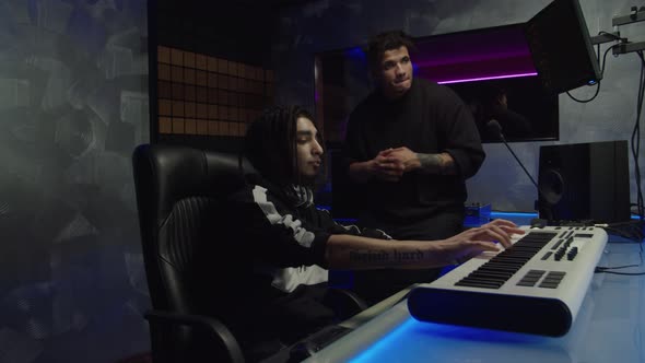 Cool Black Hip Hop Artist and Stylish Sound Producer Creating New Track in Music Recording Studio alt