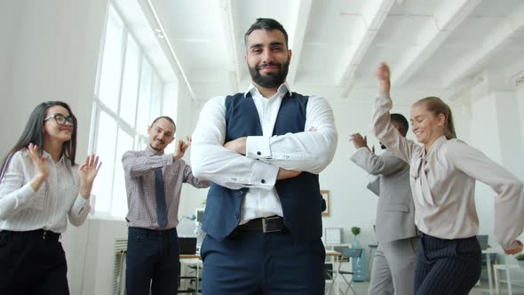 Slow Motion of Handsome Businessman Standing at Business Party Where People Dancing Having Fun alt