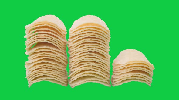 Stop motion animation stack potato chips on chroma key green screen background.
