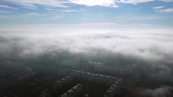 Aerial Drone View Flight Over Above Fog Mist and Roofs of Buildings in City alt