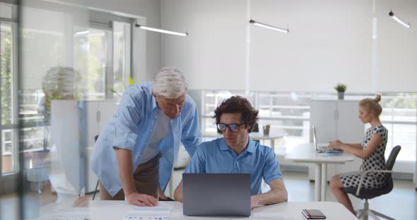 Male Colleagues Busy Working on Laptop at Office Meeting alt
