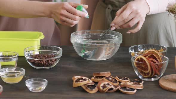 Adding Green Colorant To Bowl Of Water alt