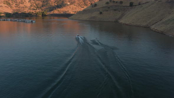 Aerial Drone Tracking Shot of a Boat and a Wakeboarder on a Mountain Lake (Lake Kaweah, Visalia, CA)
