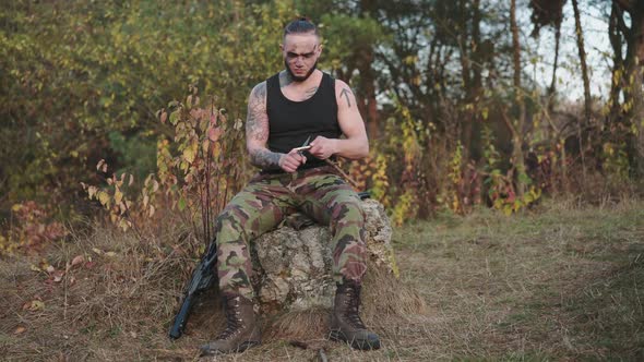Aggressive Soldier Sharpens Shavings with Knife and Throws It Down with Nervous alt