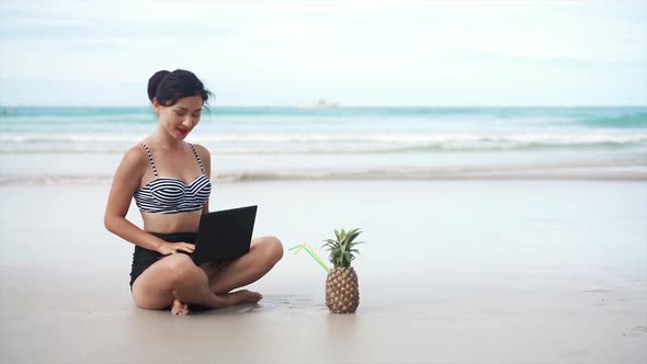 Girl Drinking Pineapple Near the Sea alt