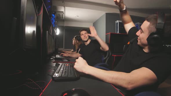 Joyful E-sport Gamers Celebrate Victory at Powerful Computers in Gaming Centre alt