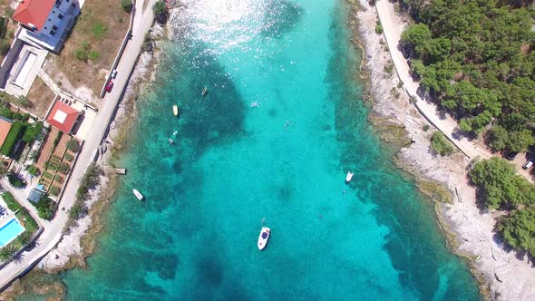 Aerial view of people swimming in turquoise bay on the island of Brac, Croatia alt