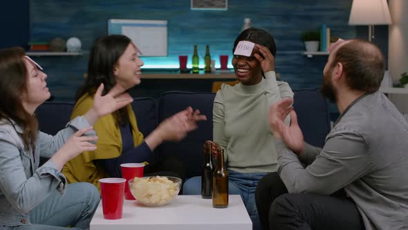 Multiethnic Friends Playing Board Game Using Sticky Notes Having Fun Together alt