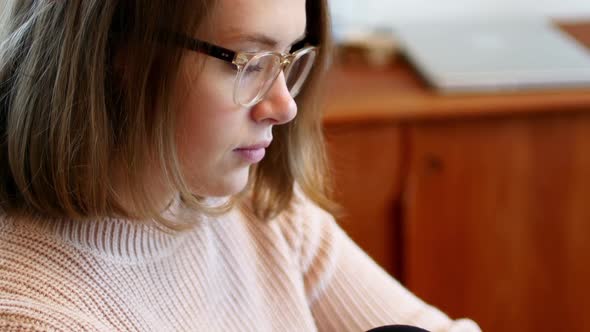 Beautiful woman text messaging on mobile phone alt