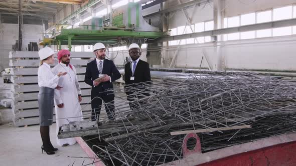 Group of international guests visiting building factory