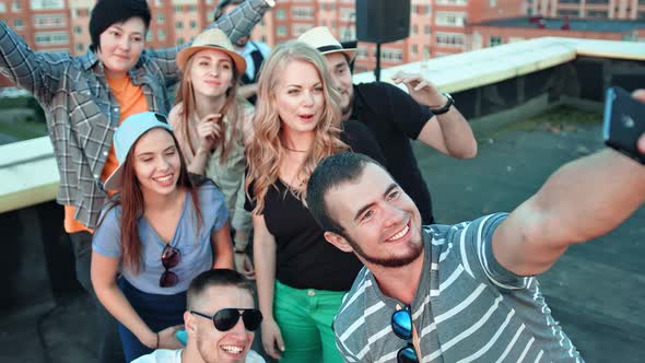 Group of Happy Student Friends in Shared Posing for Selfie Laughing Pulling Faces and Gesticulating alt