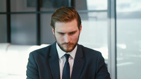 Young businessman surfing the internet using a laptop alt