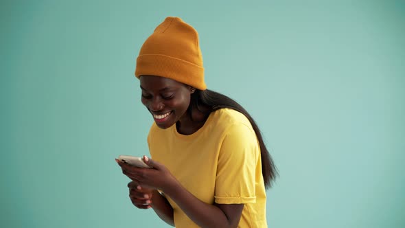 Joking African woman making selfie photo by phone alt