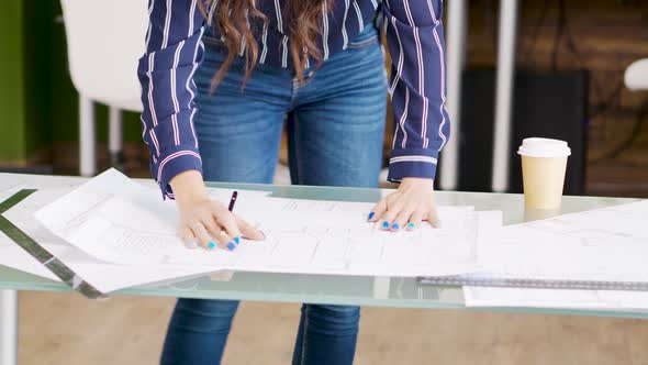 Close Up Hands of Female Architect Drawing on Blueprints alt