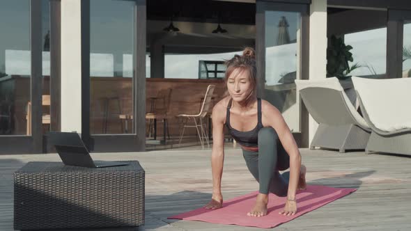 Sports Woman Doing Yoga on Terrace alt