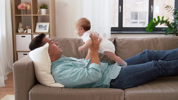 Middle Aged Father with Baby Daughter at Home alt