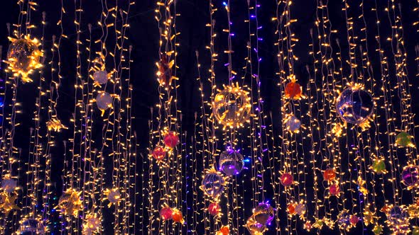 Beautiful Colorfull Holidays Decorations Sway on Wind Against Night Sky