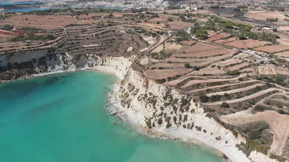 Aerial drone video from eastern Malta, Marsaxlokk area, Il-Hofra l-Kbira bay. alt