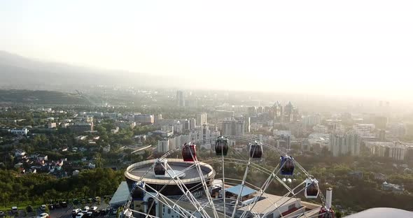 Ferris Wheel on the Green Hill Kok Tobe at Sunset alt