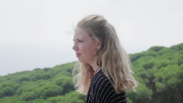 Portrait of blond girl looking at view alt