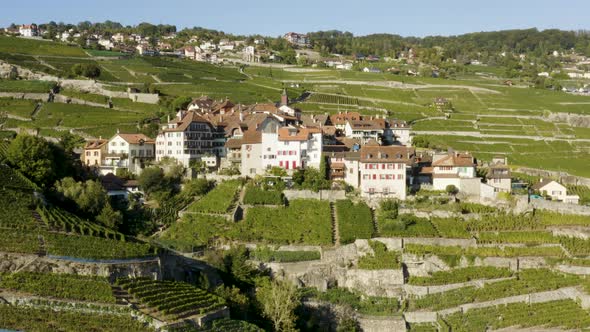 Aerial closing in on typical village in Lavaux vineyard and the orbiting to reveal Lake Léman and th alt