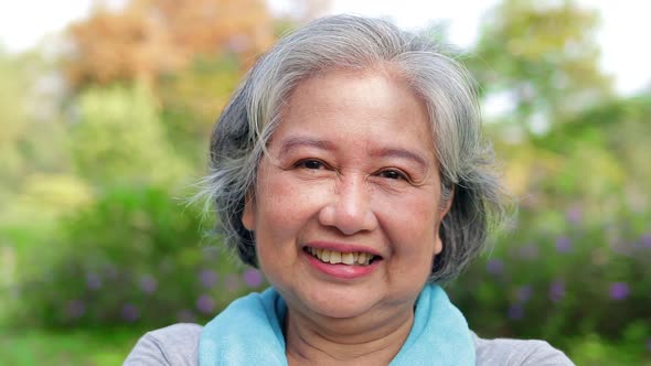 Asian elderly woman exercise in the park in the morning alt