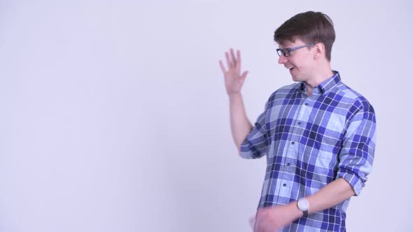 Happy Young Hipster Man Touching Something and Looking Surprised alt