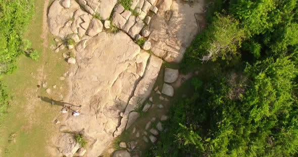 Aeriel Flyover a Couple Walking Through A Forest Park alt