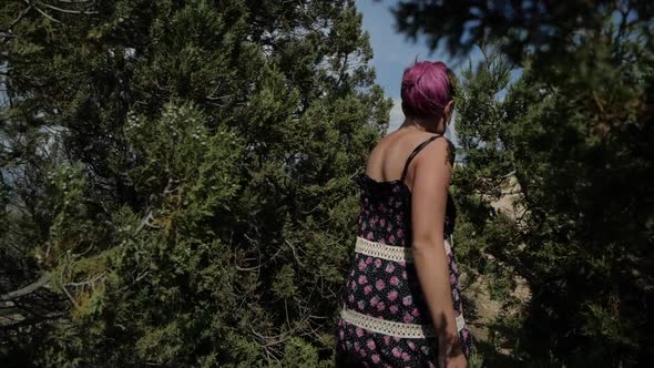 Curious Girl Wanders in the Bushes and Goes Out on a Rock with a Beautiful View alt