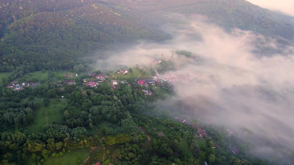 Aerial time lapse of fog over hills after rain