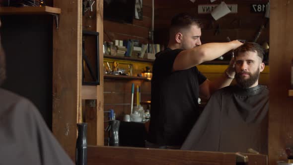 Barber Cutting Hair of Male Client